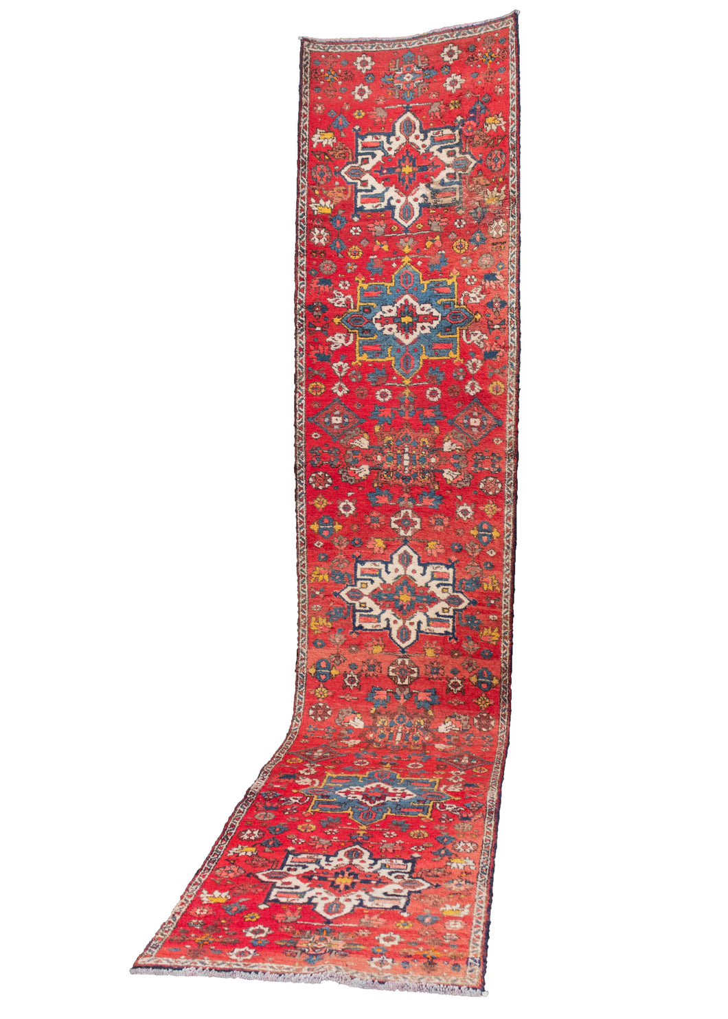 Mid-century Karaja rug with medallion design on a bright red field. Accent colors are blues, ivories, and browns. In good condition, with some moth damage throughout but foundation is still intact.