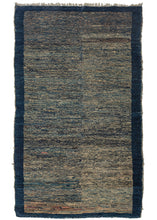 This Blue Tibetan Mat features a striated field of various blues and ivory accentuated by tiny moments of pinks, oranges, and soft browns. The rug has two subtly distinctive halves but was woven on one loom and may have been created this way to purposely reference classic Tibetan Tsuk-Truk weavings. The otherwise random color usage creates a very organic and pleasing composition that is perfectly framed by a solid blue border. 