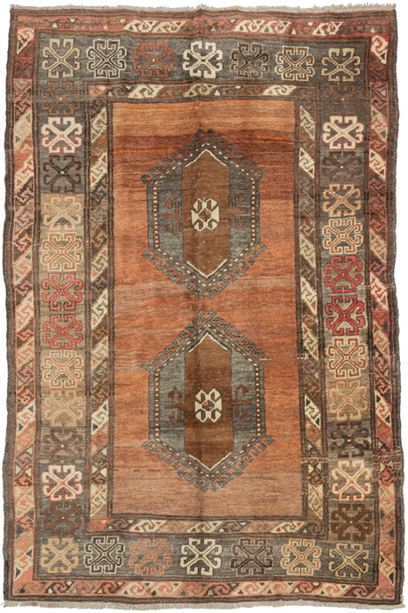 vintage turkish anatolian area rug featuring two latch-hooked medallions in silver, chocolate, and ivory on a striated burnt orange ground. A main border of large skeletal rosettes on a ground that shifts between camel and silver is sandwiched between matching minor borders of diagonal  