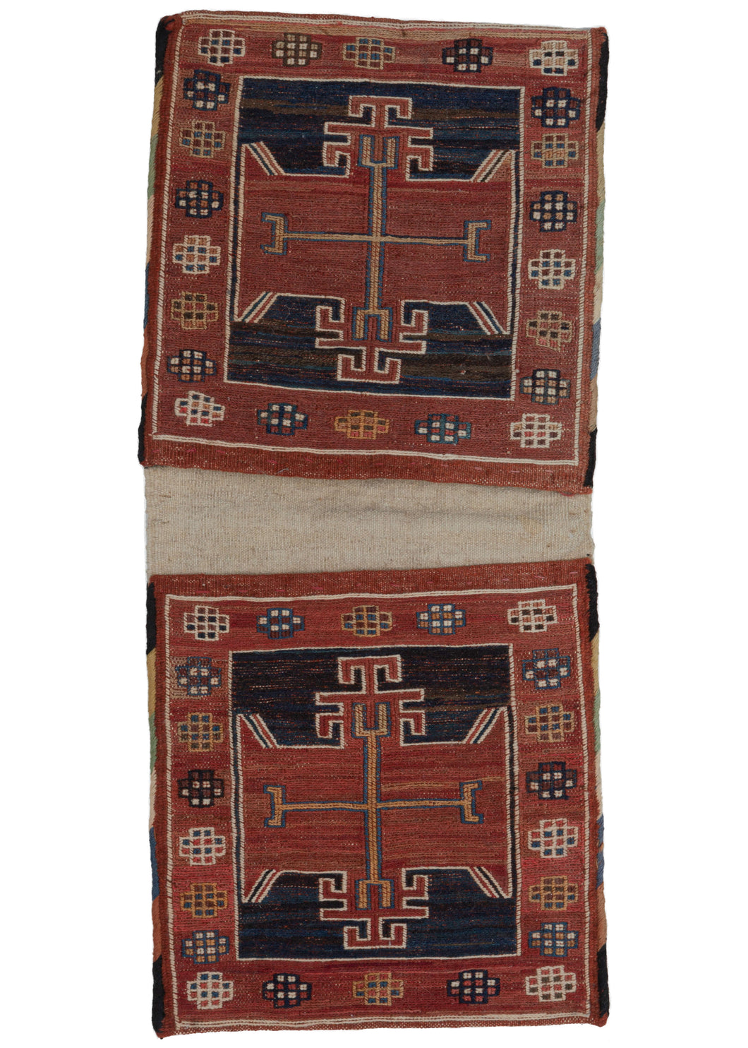 This Mid Century Caucasian Soumak Chanteh was constructed in soumak weave with a plain undyed flatwoven back with both faces featuring a red geometric rosette on a navy ground with a thin orange cruciform center.  Each bagface is framed with a border of simple rosettes composed of connected squares.