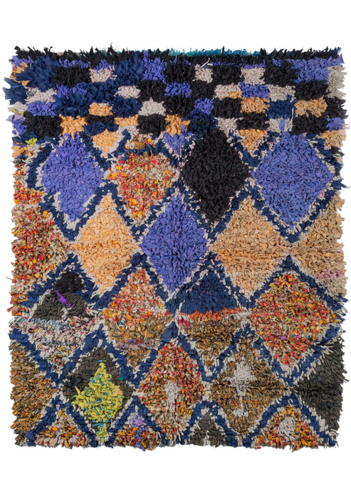 Colorful Morocan Boucheroite rug featuring diamond and checkerboard patterns. The dominant colors are the dark blue used in the outlines, and the camel and azure colors of the diamonds. This rug is very whimsical and appealing, perfect for a space in need of texture. 