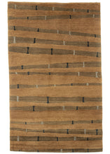 Contemporary Tibetan scatter rug featuring a simple yet soothing design and palette of light and dark browns, black and gray. The flowing lines have an organic nature reminiscent of wood grain or tiger stripes.   