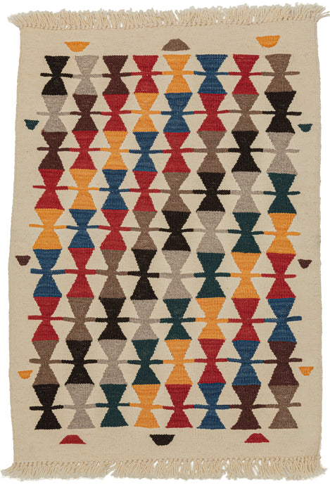 Contemporary Turkish kilim featuring columns of stacked hourglass figures in red, blue, yellow, green, gray, and light and dark brown on a bright ivory ground. The wide palette of tones is patterned on the diagonal giving the piece nice movement and energy. The kilim is woven of handspun wool and the vibrant tones are achieved with small batches of natural dyes. Made in a manner uncommon for modern production, this is sure to be well crafted for future generations. A small but impactful piece.