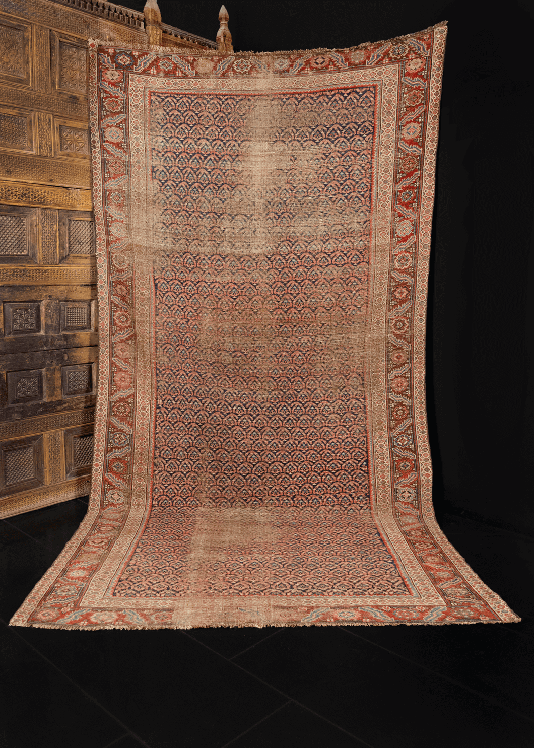 Northwest Persian rug handwoven first quarter of 20th century. Allover pattern of small both in blues and pinks. Main border classic design of leaves and flowers often found in the region. 