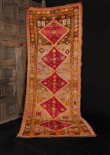 Kars runner from Eastern Anatolia handwoven during third quarter of 20th century. Five raspberry central medallions on a camel ground. Bright oranges and yellows provide contrasting details. 