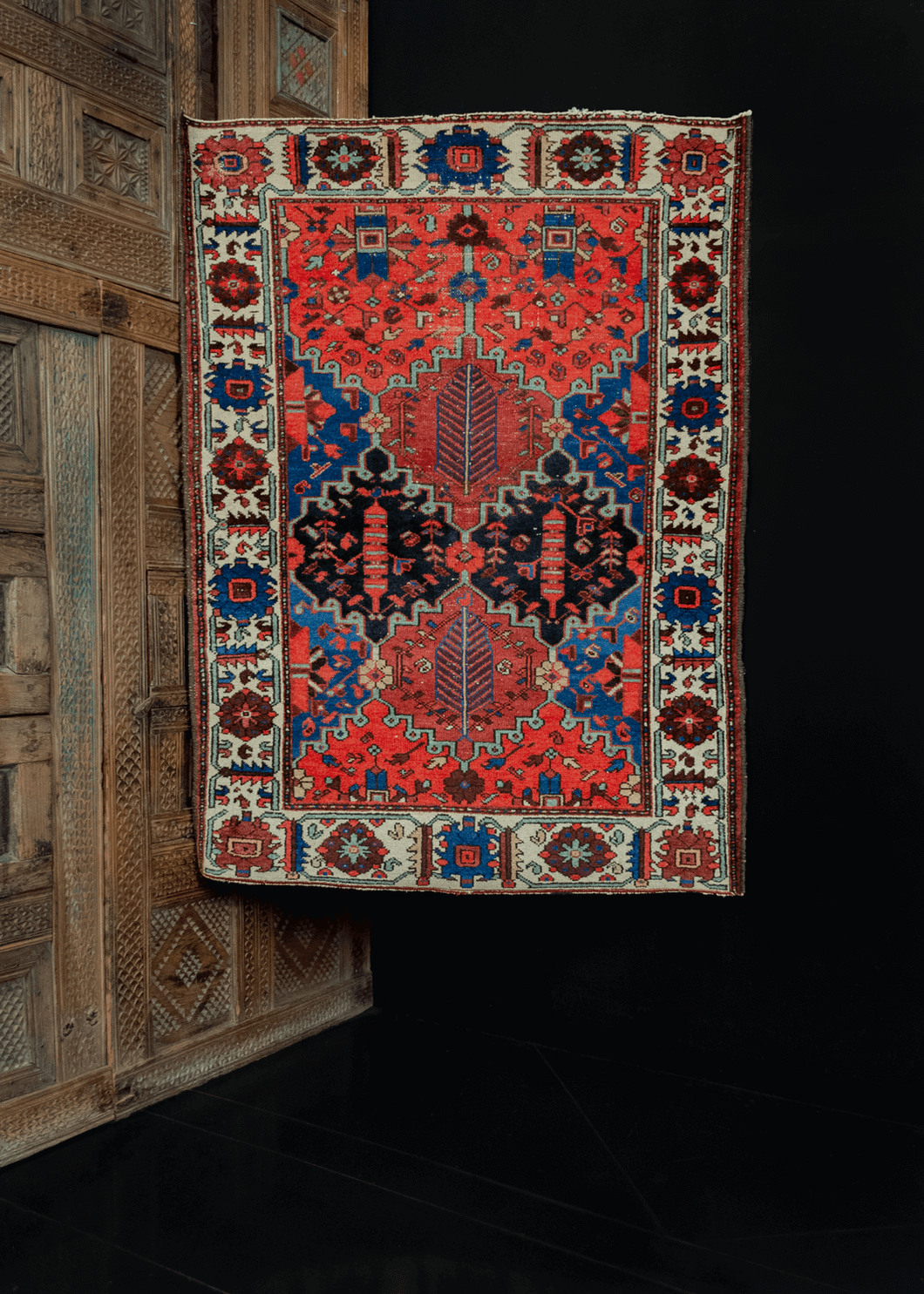 Bakhtiari Rug handwoven in Southern Iran during second quarter of 20th century. Garden design with interlocking polygons. Bold blues and reds paired with soft ivories and browns. 