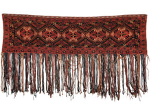Ersari Turkmen trapping featuring a classic Turkmen color palette and design, with a small main field composed of Turkmen güls, framed by six small borders all featuring classic geometric designs. The color palette is composed of earthy reds, oranges, browns, and deep blues, with cream details and a cream wool warp which is used to create the fringe.   In excellent condition, with no sign
