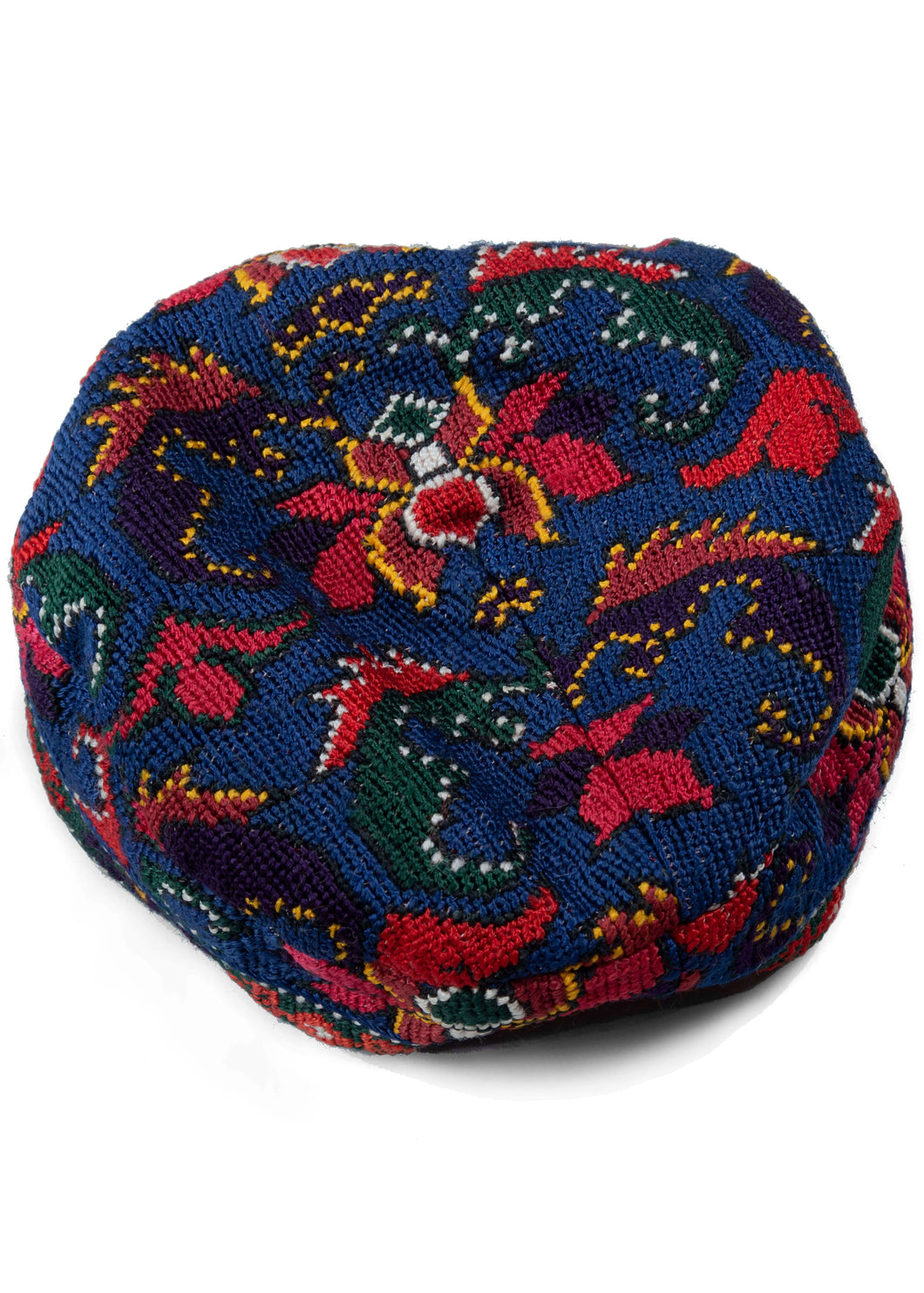 Embroidered Uzbek skull cap cross stitched of silk and features a variety blossoming palmettes in bright reds, greens, purples and yellow on blue ground. The edge of the skull cup is finished nicely with a thin border panel of opposing tridents.