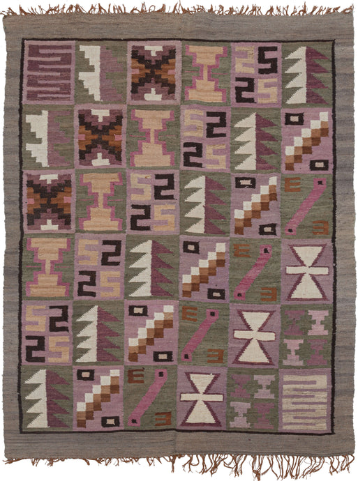 This Vintage Peruvian Kilim features a grid of diagonally repeating squares full of various abstracted shapes and symbols. It is woven in two panels which are sewn together and utilize tones of soft cochineal purples, undyed browns, and greens with pops of yellow. The colors and style suggest it was woven by the talented weavers in the Ayacucho region. Very soft and lightweight, can double as a multifunctional textile or wall tapestry.