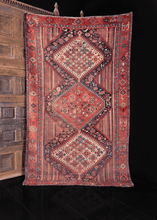 multicolor khamseh rug from early 20th century. three central medallions on a multicolor vertical stripe field