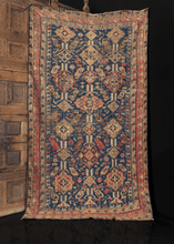 Caucasian Soumak rug with lozenge and diamond pattern on indigo blue ground. in fair condition with some wear