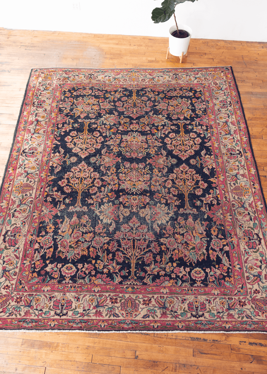 Image of mid century Turkish Sparta rug with dark indigo field and all-over psychadelic floral design