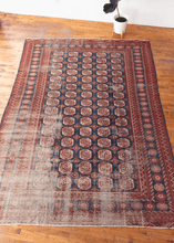 vintage bokhara rug with classic gul pattern in red and blue color palette with some wear especially in the lower left hand corner but foundation is still intact