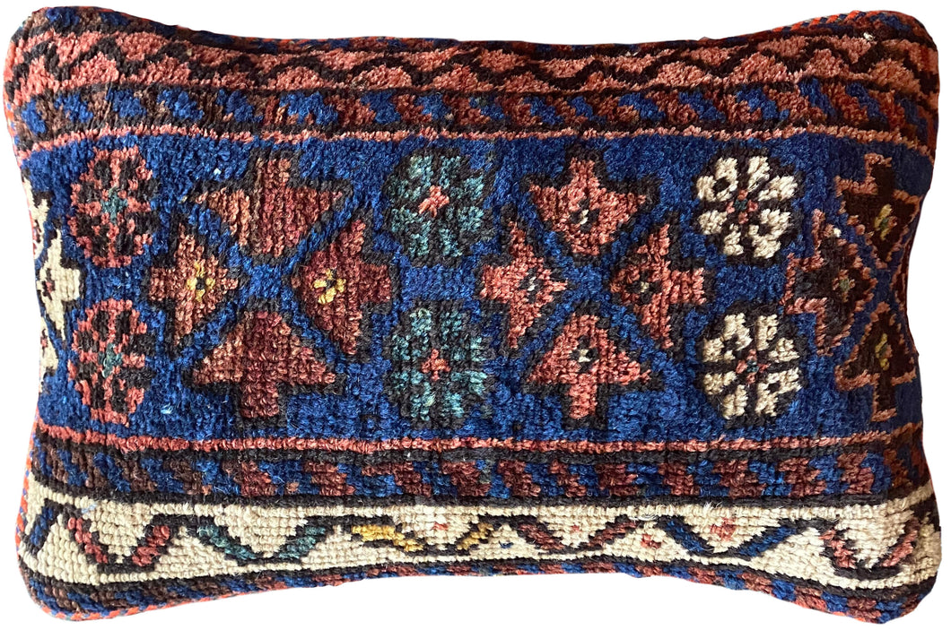 Pillow crafted from fragments of handwoven antique Kurdish rug 
