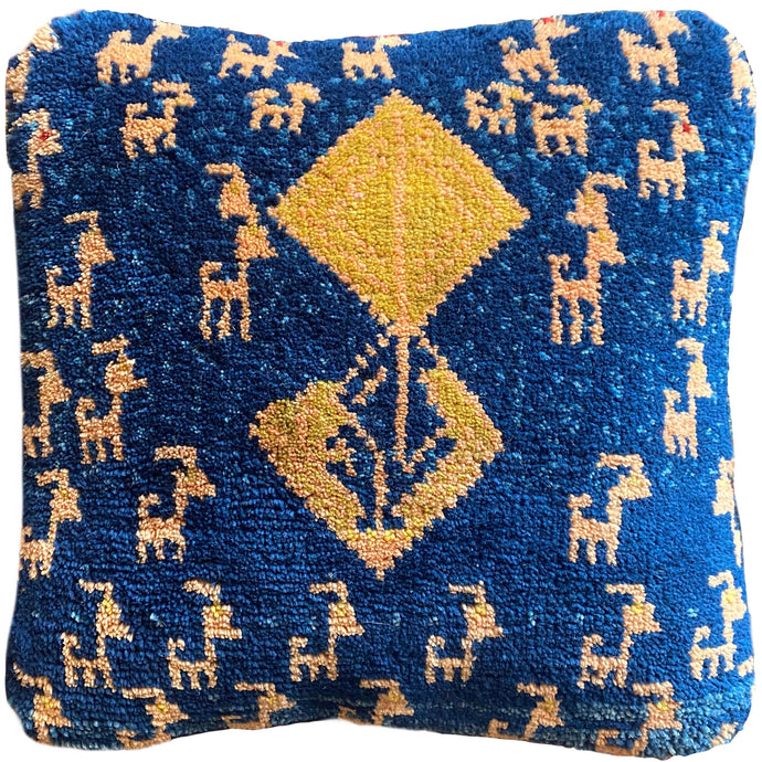 This Gabbeh pillowcase was recently handwoven in Southern Iran.   It features simple vegetal and zoomorphic patterning on big blocks of rich color.   With a densely woven pile making for a plush pillow.