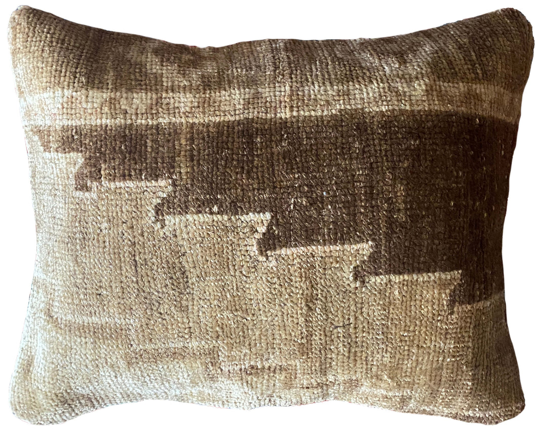 Pillow crafted from fragments of handwoven antique Oushak rug from Turkey.