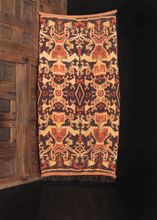 Vintage ikat handmade on the island of Sumba in Indonesia. Crafted in two strips featuring color palette of brown, gold and terra-cotta with indigo blue details. 