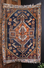 Afshar rug handwoven in Southwest Persia during the first quarter of the 20th century. Beautiful indigo blues and burnt orange in a geometric design with small asymmetries. 