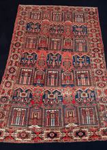 Bakhtiari Rug handwoven in Southern Iran during second quarter of 20th century. City-scape geometric design in red, blue, brown, yellow and ivory with a large main border. 