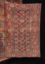 Bidjar rug handwoven during fourth quarter of 19th century. Wide border, deep blue field, and rosette pattern. Rusty oranges, reds and blues. 