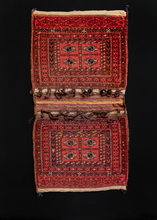 Double saddlebag or "Khorjin" handwoven by Turkmen during first quarter of 20th century. Braided loops at tops of both bag faces. Four guls in the center. Reds, browns, blues and yellows/ivories. 