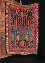 Lori rug handwoven in Southern Iran during the early 20th century. Deep blue field with a beautiful brash. Latticed panels with cypress trees make up the central design. 