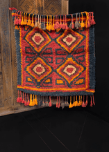 Vintage Julkhyr handwoven during third quarter of 20th century in Uzbekistan. Four diamond devices with surrounding polygons. Red and orange with black outlining and framing. 