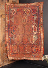 Qashqai rug handwoven at turn of the 20th century in Southwest Iran. Red, blue and yellow with white. Five rows of encapsulated botehs in rows of three or four. 