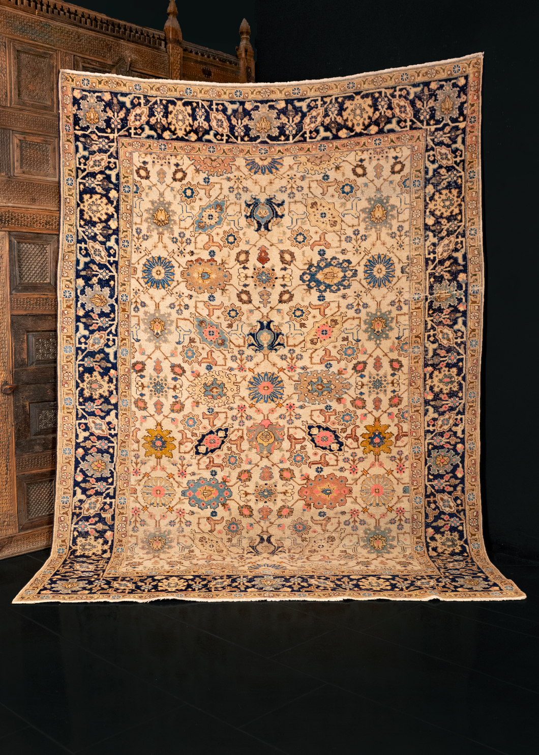 Mid century Tabriz rug handwoven in Northwest Iran. Design is multiple interconnected palmettes. Ivory ground and flowers in blue, yellow, and pink. 