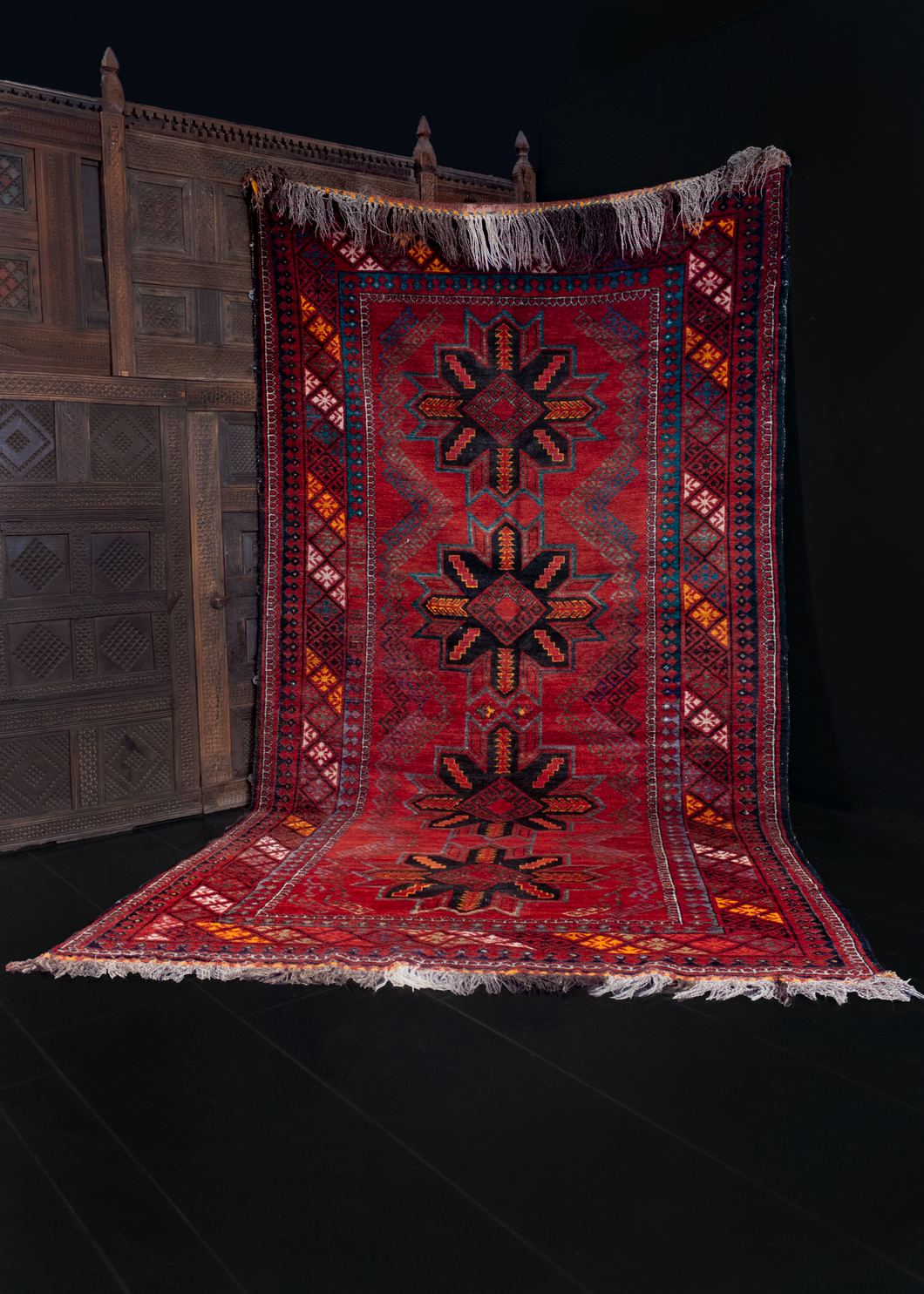 1968 Uzbeki rug with date woven into design of four eight pointed stars on deep red field with latchhooks and diagonal diamond main border. In excellent condition