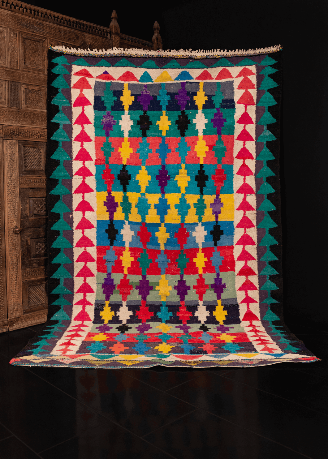 Persian vintage kilim with a colorful geometric pattern of stepped crosses on a striped background