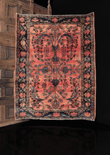Lilihan rug with central mirrored curvilinear design in shades of blue on a peach ground 