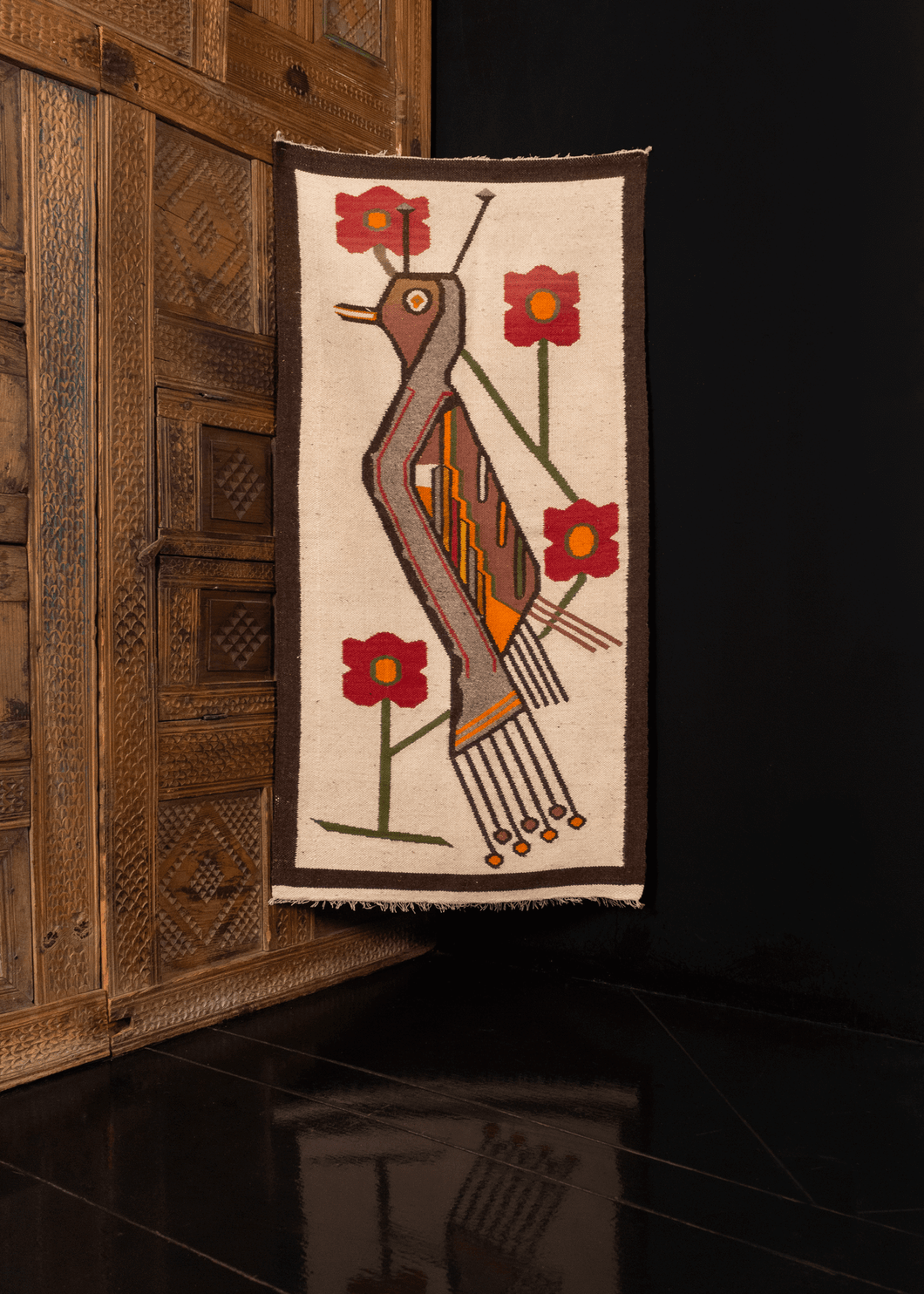 Andean textile with stylized bird and flowers on white field with thin brown border