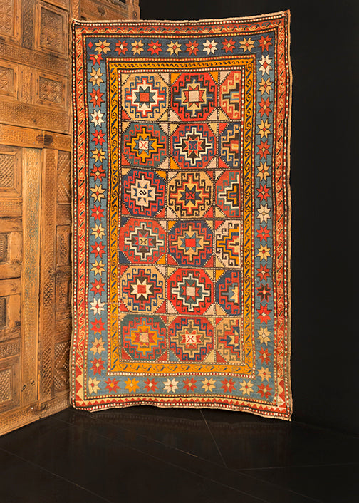 Moghan Kazak rug handwoven during late 19th century in the Caucasus. Vibrant palette that highlight multiple 