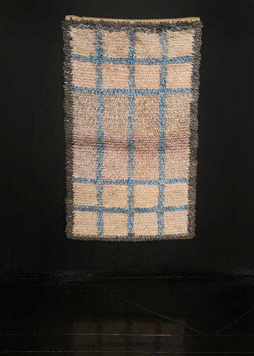 Mid century Rya shag rug handwoven in Sweden. Subtle geometric pattern of a symmetrical grid echoing a window pane. Shades of grey make the field with a grid pattern in light blue. 