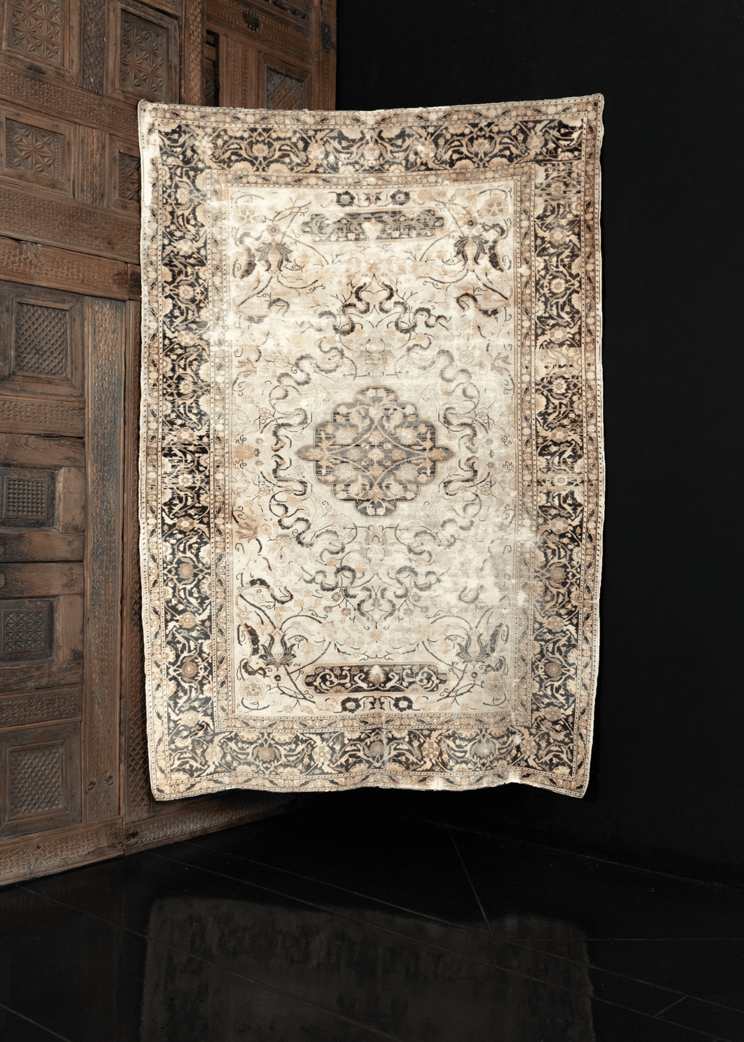 Image of silk Keyseri rug featuring delicate floral pattern on white field with subtle brownish green filigree.