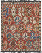 This Kuba design rug was woven in India during the 21st century.  It features an all-over design of geometric devices in blue, green,  wheat, ivory and chocolate on a red ground. Framed with a thin diamond border and wonderfully embellished with dark brown fringes. Woven in pile with the patterning of a classic Kuba rug from the Caucasus.