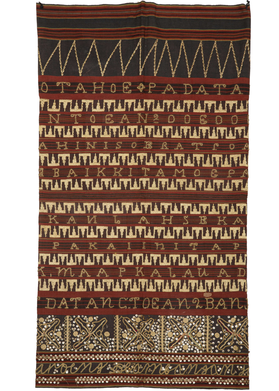 Indonesian Sumatran tapis cotton and metal sarong featuring a ground fabric is striped red and black and embroidered with gold thread. Text is commonly used for decorative and ritual effects. The text on this particular piece is written in a mix of Bahasa Indonesia and the local Lampung language and features well-wishes for the wearer of the tapis. 