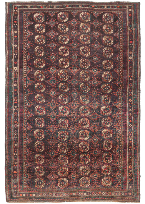 Large Afghan Turkmen purple toned rug featuring a traditional Tekke gül design with both burnt and bright orange, ivory, and green accents on a soft multi-shade aubergine ground. A precursor to the 