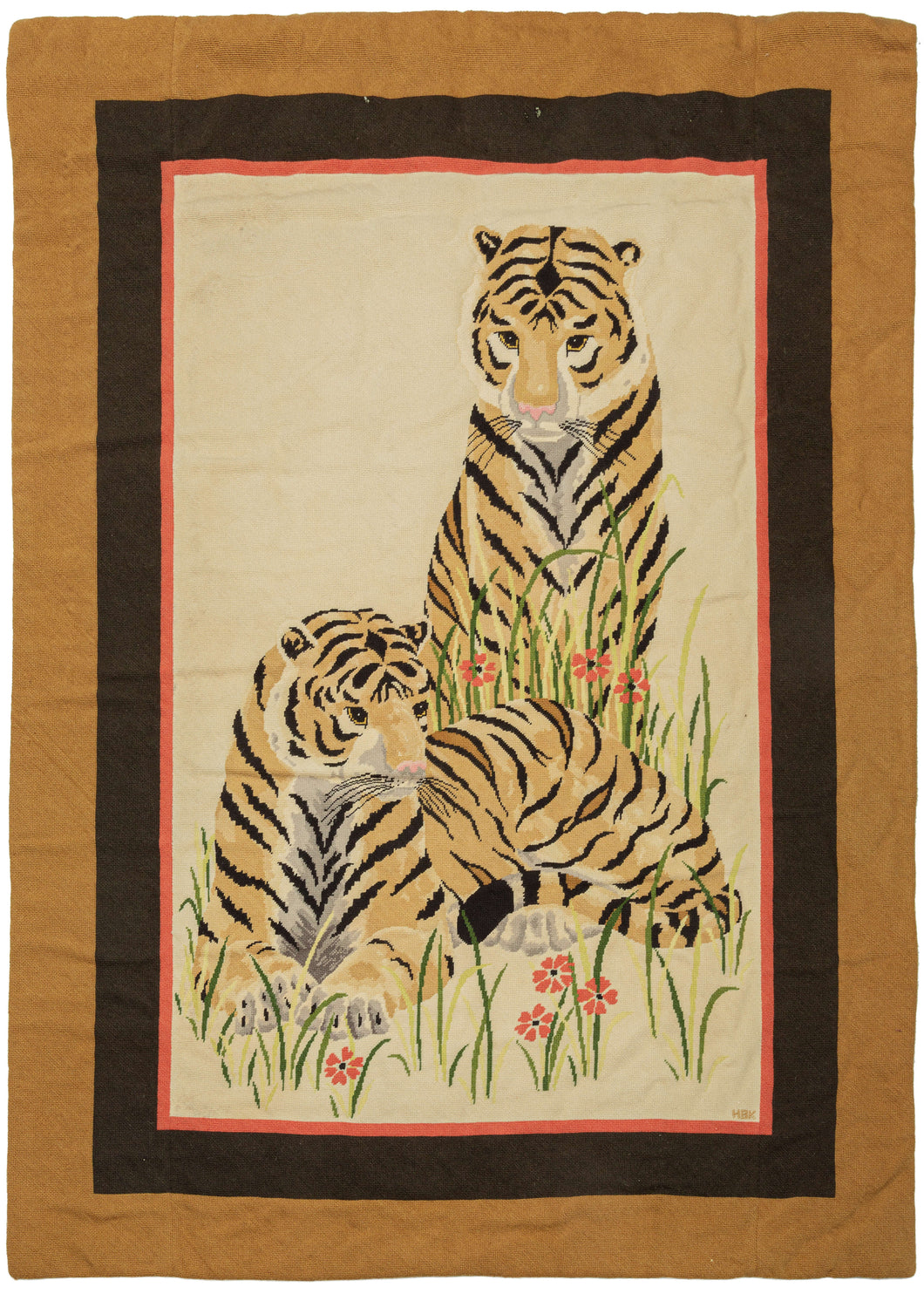 This Signed Tigers Needlepoint features a pair of tigers lounging amongst tall grass and wildflowers. It is simple and straightforward yet still striking in its warmth and beauty. The tigers are impeccably executed and stand out against the open cream backdrop and are perfectly framed by three increasingly wider bands of red, black, and copper. The intitials 
