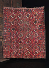 Central Asian Ersari Turkmen red area rug featuring a repeat bpattern of orange, white and green guls
