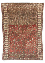 Mid Century NW Persian handwoven wool rug with washed out tones of pale madder red and taupe, featuring a chain link design throughout central design, as well as birds and flowers