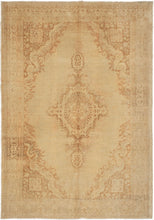 This Kayseri rug was handwoven in Turkey during the third quarter of the 20th century.  It features a central medallion on an open field with four cornices. The ornate patterning is softened by the limited palette of beiges and browns. Soft tones and limited contrast make this a very easy rug to decorate around.