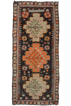 Mid century Caucasian kelleghi kilim featuring a triple medallion geometric design on a dark brown field. The medallions, alternating beige, and orange contain dainty flowers and leaves arranged in a diamond shape. The rest of the field is filled with various geometric shapes and symbols. At the top of the field are an inscription with numbers and letters reading: "24 .3.960   SK".