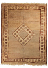 Mid century European shag carpet featuring a minimalist geometric design with a central medallion and plain camel field. The main border mirrors the patterning within the diamond medallion. 
