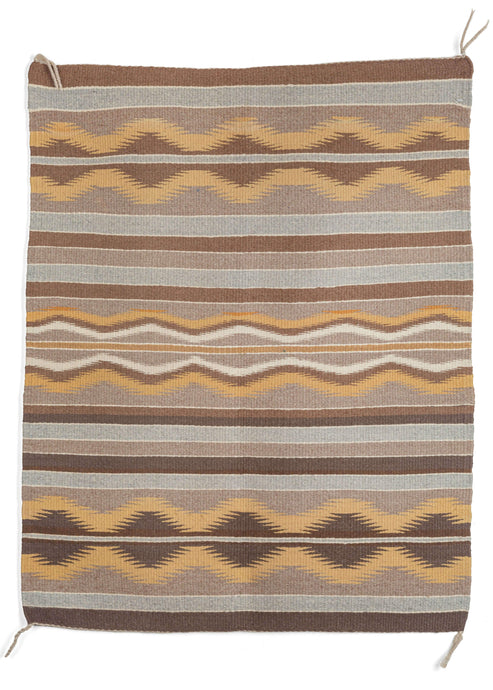 Mid century SW Navajo Chinle kilim featuring a pared-down color palette of greys, blues, browns, and yellows. The design is composed of straight and curved bands, separated by thin white lines. 