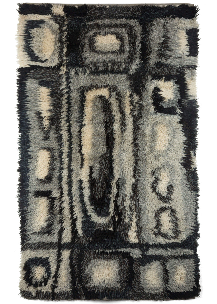 Mid century Swedish Ryya featuring a geometric design in black, white, and grey. Overall it has an abstract grid like design, filled with asymmetric rectangles, ovals and squares. The geometric design mixed with the long shaggy pile, gives a very modern feel. 