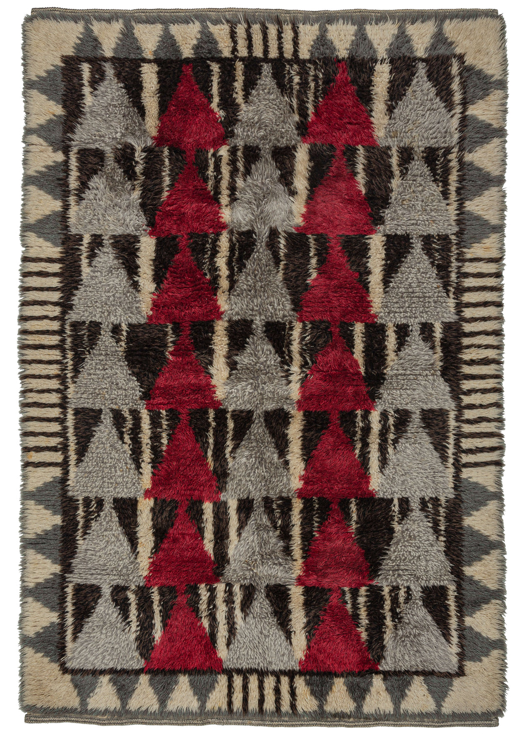 This Mid Century Rya Rug features a geometric design in black, white, red, and both gray and silver. The field is composed of alternating columns of red and silver triangles each stacked seven high against a ground of black and white wandering stripes. It is framed by a pattern of gray triangles and hash marks on a white ground. The geometric design mixed with the long shaggy pile gives a very modern feel.   In very good condition with minimal wear. Pile is shaggy, the handle is heavy but soft. 