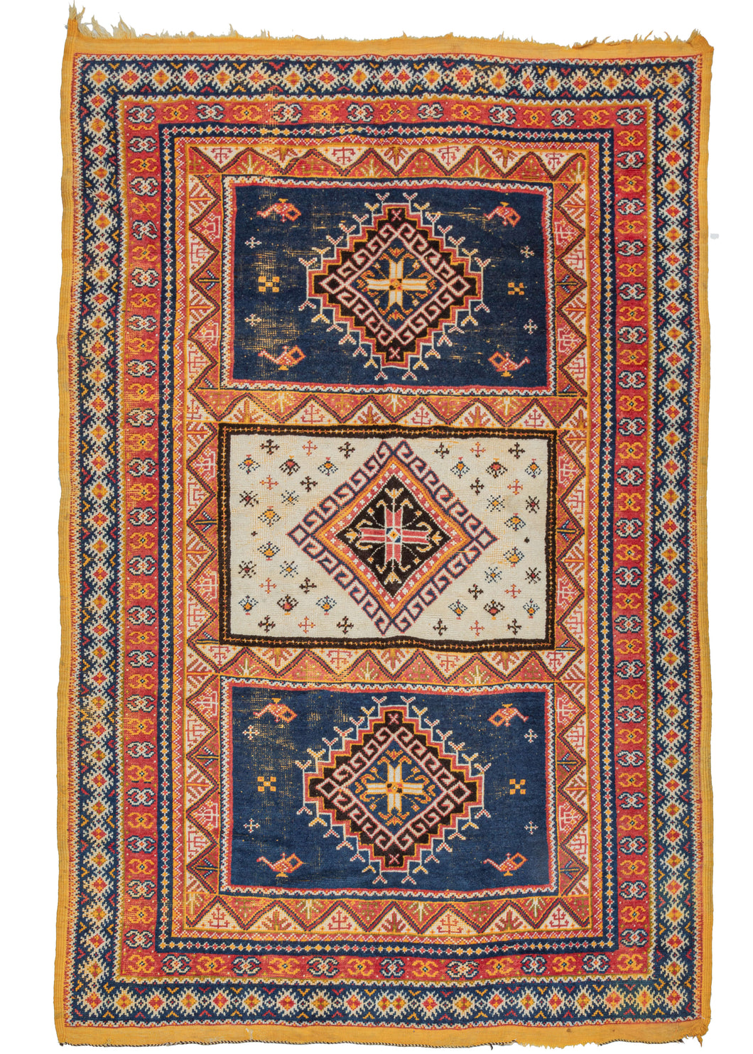 Mid century Moroccan Taznakht area rug featuring a field of three compartments each with a central latch-hooked diamond motif. The center compartment is bright ivory and filled with small protection symbols. The top and bottom compartments feature a more sparse design around a stepped diamond on a navy ground. Of note in the top and bottom compartments are the depiction of oil or 
