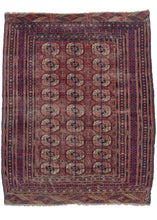 Mid century Tekke Turkmen area rug composed of a repeat design of the classic Tekke guls on a red ground with accents of navy, ivory, and a soft sherbert. It is surrounded by multiple minor borders where the brighter magenta takes precedence offering a stark contrast to the calmer red of the field and skirt borders on the top and bottom